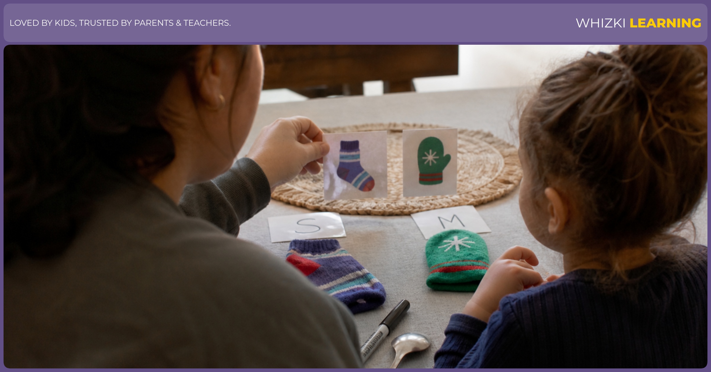 A caregiver and child sort a sock, mitten, spoon, and marker into two first-sound piles at a kitchen table.